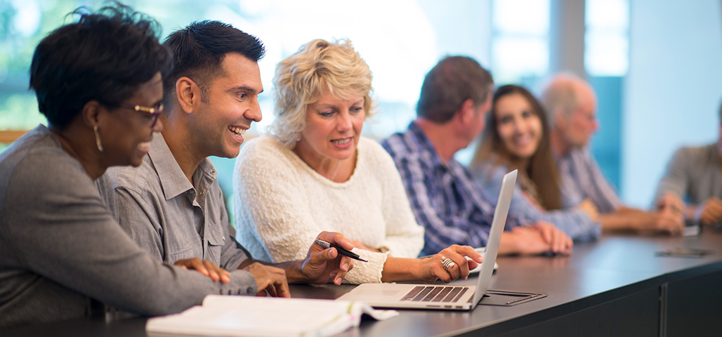 Group of students from all ages in a classroom.